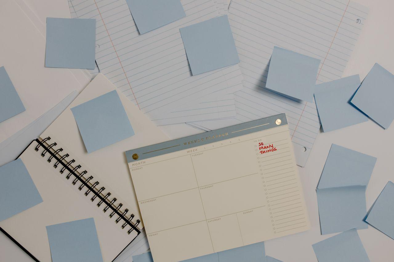 Notes, papers and a notebook organized by topic on a desk
